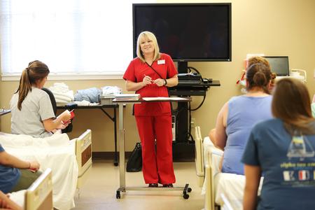 Jennifer Delk, assistant professor of nursing, introduces MSN students to the equipment they'll be using in the Skills Lab in Providence Hall.  - Photo by Kristi McMurry Woody