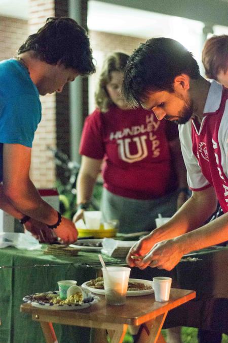 MacLin Williamson, junior biology major, helps prepare S'mores alongside Cody Curtis, Assistant Residence Director, during Residence Life's Progressive Snacking. - Photo by David Parks