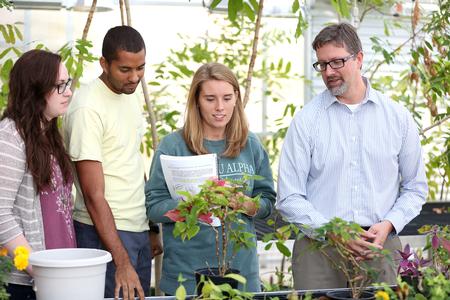 Michael Schiebout, assistant professor of biology, takes students through the greenhouse during a botany lab. - Photo by Kristi McMurry Woody