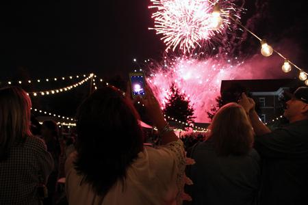 Parents, siblings, and students take snapshots of the dazzling fireworks at the Union Night event during Family Weekend. - Photo by Sol Bee Park