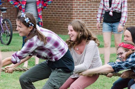 Craig residents laugh during the tug-of-war in the annual DF Olympics on the Heritage Complex lawn. - Photo by David Parks