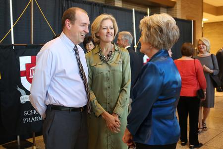 The Flippen family chats with Debbie Newell at the 18th annual Scholarship Banquet, featuring New York Times columnist and author David Brooks. - Photo by Kristi McMurry Woody