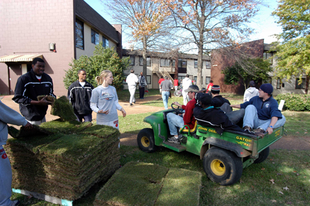 Mandy Beth & David Niven worked with members of the basketball teams to lay sod around the dorms during Day of Remebrance. - Photo by Morris Abernathy
