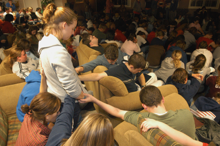 Students joined hands in prayer during a Faith in Practice conference led by Voddie Baucham in the Watters Commons. - Photo by Kristen Nicole Sayres