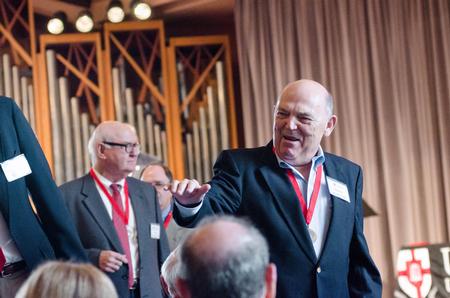 Harry Raney, class of '66, waves to an old friend in the audience of homecoming chapel. - Photo by David Parks