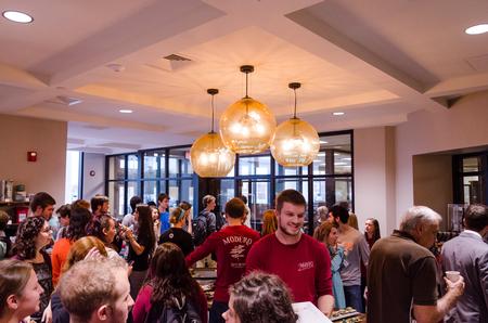 The floors of the Modero coffee shop in the Logos are flooded with students and alumni, after its official opening and dedication ceremony. - Photo by David Parks