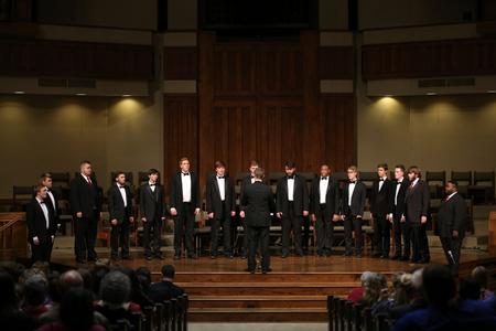 The men's choir, conducted by Dan Musselman, assistant professor of music, performs during the Fall Choral Concert held at First Baptist Church. - Photo by Kristi McMurry Woody