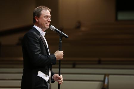 Chris Mathews, chair the department of music, welcomes guests to the Fall Choral Concert and introduces the University Singers. - Photo by Kristi McMurry Woody