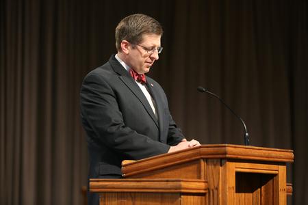 Ray Van Neste, professor of Biblical studies, gives the benediction for Homecoming chapel. - Photo by Kristi McMurry Woody