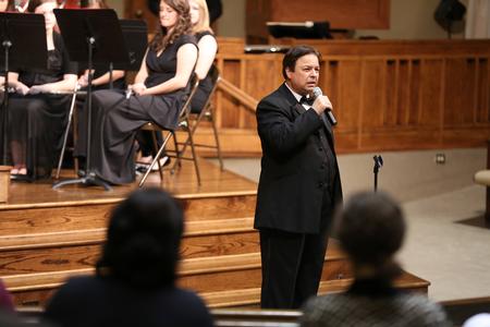 Michael Mann, assistant professor of music, speaks to the audience during the Symphonic Band's fall concert.  - Photo by Kristi McMurry Woody