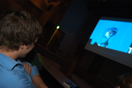 Junior digital media studies major Nic Pfost watches Tyson Cadenhead's <i>The Perfect Dorm Room</i> along with a roomful of film fans at the 2004 Student Film Festival. Nic won the Jury's Award for a short form film that night for <i>The Femail Box.</i> - Photo by Kristen Nicole Sayres