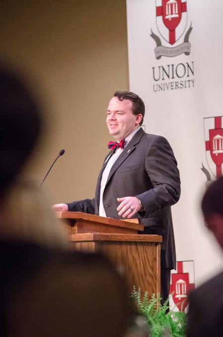 Presentation of awards is preceded by word from Josh Clarke, director of alumni and annual fund, during the Meritorious Service Awards Banquet. - Photo by David Parks