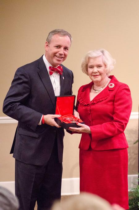 Dub Oliver, president of the university, presents Louise Towater Lynch-Mills with the Lest We Forget Award during the Meritorious Service Awards Banquet in the Carl Grant Events Center. - Photo by David Parks