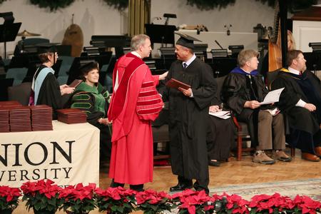 Students receive their diplomas at fall commencement services.  - Photo by Kristi McMurry Woody