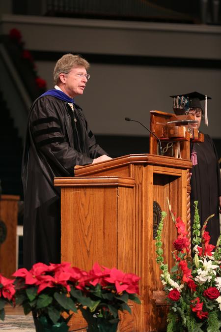 Mark Bolyard, professor of biology and department chair, gives the benediction during fall commencement services.  - Photo by Kristi McMurry Woody