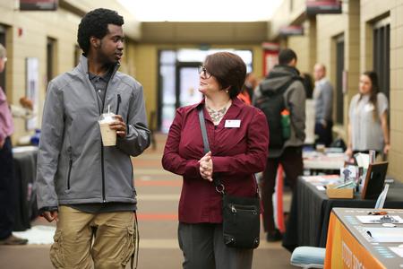 Korey Adams, freshman biology major, talks with Victoria Malon, assistant professor of language and coordinator of study abroad, during the Study Abroad Fair. - Photo by Kristi McMurry Woody