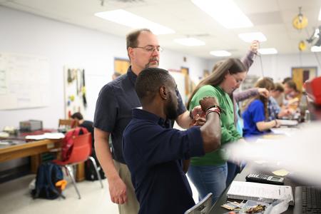 Randal Schwindt, professor of engineering, helps his students with their lab assignment. - Photo by Kristi McMurry Woody