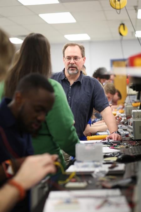 Randal Schwindt, professor of engineering, works with his engineering students during a lab assignment. - Photo by Kristi McMurry Woody