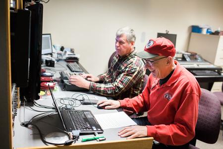 Ray Eaton, broadcasting technician, and Steve Beverly, associate professor of communication arts, set up the day's broadcast for Jackson 24/7. - Photo by Kristi McMurry Woody