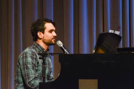 Cody Curtis, assistant residence director, leads music during chapel. - Photo by Gretchen Foels