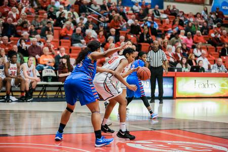 Fredi Nielson dribbles around her West Georgia opponent during the first round game of the Gulf South Conference Tournament. - Photo by Kristi McMurry Woody