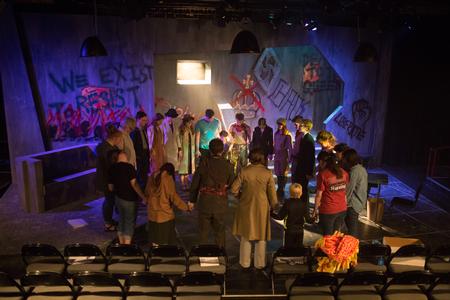 The cast and crew of The Queen and the Rebels gather to pray before their performance in the W.D. Powell Theatre. - Photo by Kristi McMurry Woody