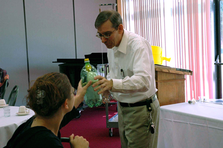 David Ward, professor of physics, demonstrates an experiment on air pressure to fellow educators at the science fair luncheon and organizational meeting. - Photo by Amanda Herron