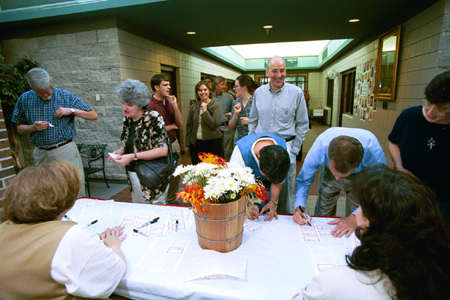 Faculty & staff each wear a name tag at the Faculty/Staff Dinner to help the new members of the <i>family</i> get acquainted with their new environment. - Photo by Jim Veneman