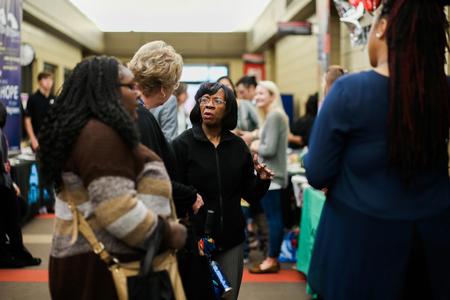 Rhonda Hudson, professor of social work, talks with guests at the Social Work Awareness Day event in the SUB. - Photo by Kristi McMurry Woody