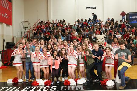 Guests of the undergraduate admissions event Bulldog Days pose with the cheer squad during halftime of the first round of the NCAA DII South Region Tournament. - Photo by Kristi McMurry Woody