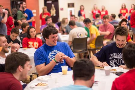 Fraternity brothers enjoy the performances over pancakes and orange juice at Chi Omega's Pancakes & Karoke. - Photo by David Parks