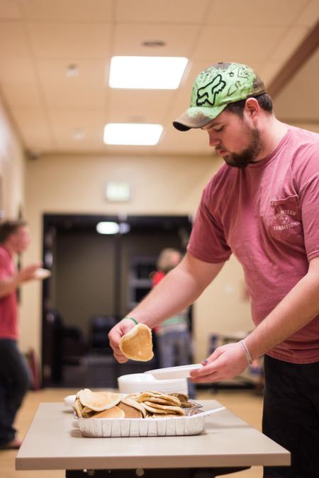 Jordan Daughrity, junior business administration major, fills his plate with delicious pancakes at the Pancakes & Karaoke Party benefiting Make-A-Wish® Mid-South. - Photo by David Parks