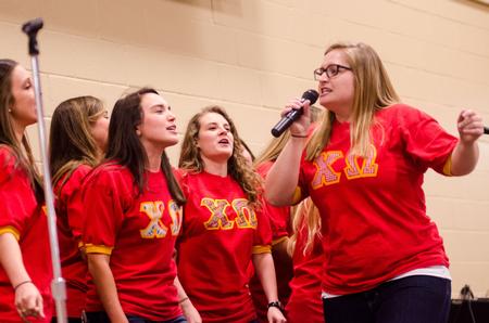 Stephanie Olford, junior psychology major (right), steals the show at Chi Omega Pancakes & Karaoke Party. - Photo by David Parks