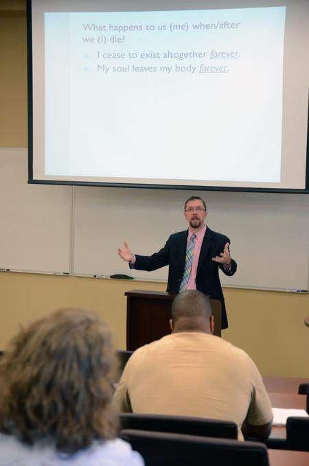 Justin Barnard, associate professor of philosophy, speaks on Death and Dying during a Town & Gown lecture series in Providence Hall. - Photo by MiKalla Cotton