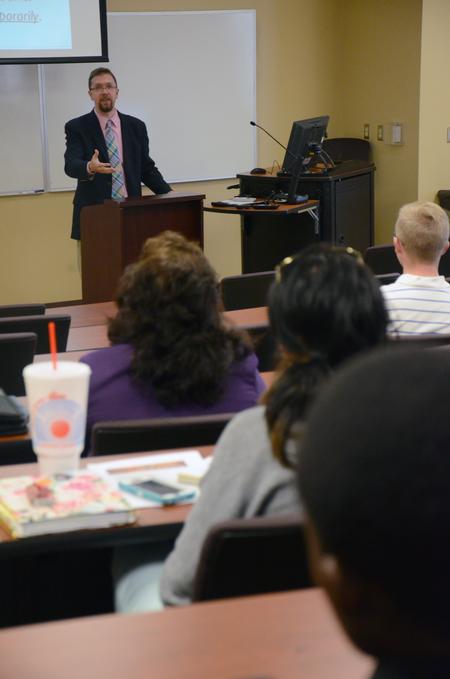 Justin Barnard, associate professor of philosophy, speaks during a Town & Gown Death & Dying lecture series in Providence Hall.  - Photo by MiKalla Cotton