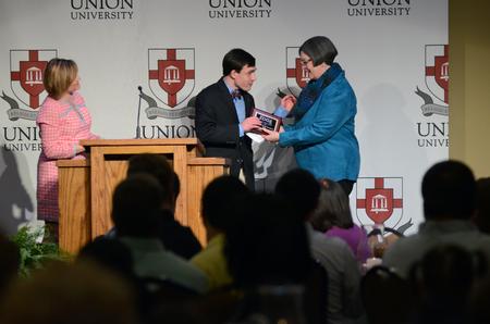 Seth Ratcliff, EDGE student, presents an award during the EDGE Banquet in the Grant Events Center.  - Photo by MiKalla Cotton