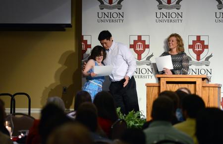 Kevin Ung, assistant director of Union EDGE, awards Kelsey Layman, EDGE student, during the EDGE Banquet in the Grant Events Center. - Photo by MiKalla Cotton