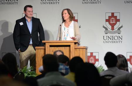 Ethan Wilson, EDGE student, and his mother Carla conclude the EDGE Banquet with a prayer in the Grant Events Center. - Photo by MiKalla Cotton