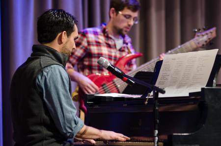 Cody Curtis, assistant residence director, performs pieces from his composition, <em>Romans</em>, during chapel. - Photo by Gretchen Foels