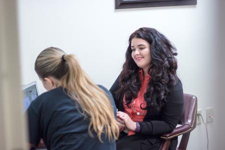 Esperanza Gonzalez, programming coordinator/student success advocate, helps an undergraduate create a strong résumé during the Vocatio Center's Walk-in Monday. - Photo by David Parks