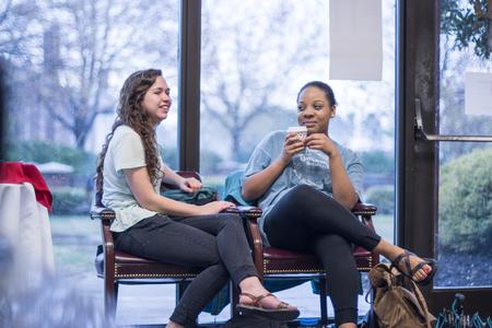 Juniors Cara Lunsford, French and TESL major, and Angelica Shipps, public relations major, chat while waiting during the Vocatio Center's Walk-in Monday.  - Photo by David Parks