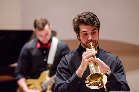 Joey Moore, senior music major, plays trumpet as part of a trio in the jazz band concert.  - Photo by David Parks