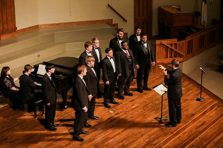The men's choir under the direction of Dan Musselman, assistant professor of music, performs during the spring choral concert at First Baptist Church. - Photo by Kristi McMurry Woody