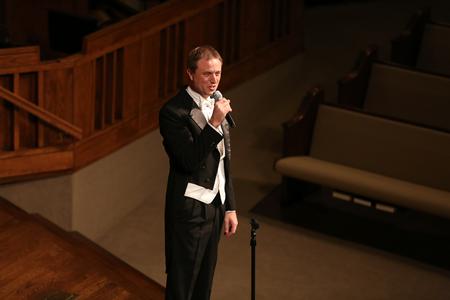 Chris Mathews, professor of music and department chair, greets the audience at the spring choral concert.  - Photo by Kristi McMurry Woody