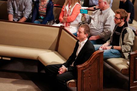 Chris Mathews, who will be transitioning to another university next semester, watches his current and former students perform a special arrangement of Be Thou My Vision in his honor.  - Photo by Kristi McMurry Woody