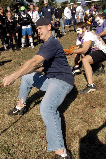 Senior Daniel Verbist, P.P.E major, heads the SAE rope pull team in the Greek Olympic competition, while freshman Stephen Ellis and senior Drew Day attempt to pull their own weight. - Photo by Kristen Hiller