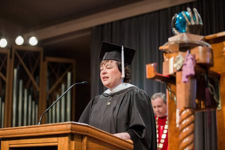Ashley Blair, assistant professor of communication arts, prays at the start of Awards Day Chapel. - Photo by Kristi McMurry Woody