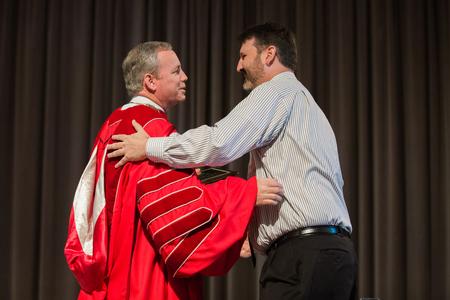 Cam Tracy, web development agent, accepts the Staff Member of the Year award during Awards Day Chapel. - Photo by Kristi McMurry Woody