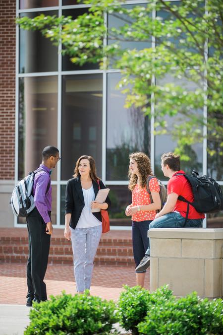 Colleen Trent, assistant professor of economics, talks with students outside The Logos. - Photo by Kristi McMurry Woody