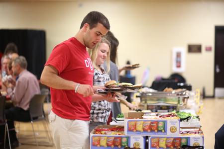 Allen Bradley, accounting graduate, goes through the food line at the Senior Send-off event held as part of Senior Week. - Photo by Kristi McMurry Woody